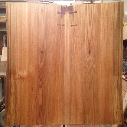 A bookmatched red elm coffee table top