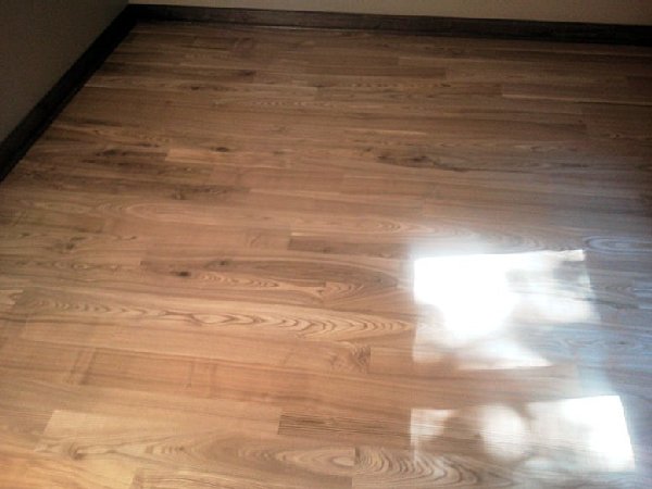 A beautiful black ash, wide plank floor we built.