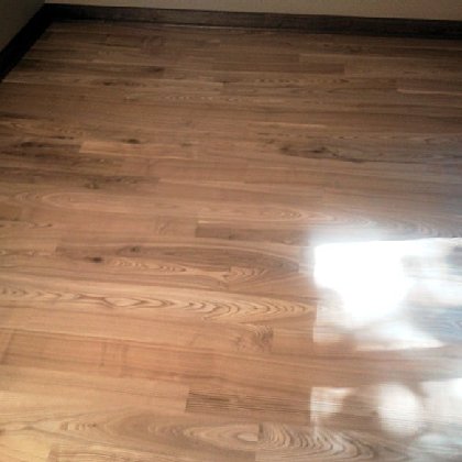 A beautiful black ash, wide plank floor we built.
